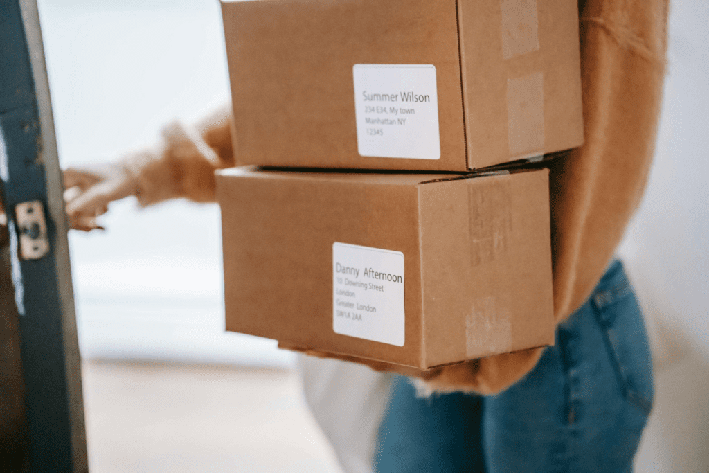 a woman holds delivery boxes – AMS Fulfillment