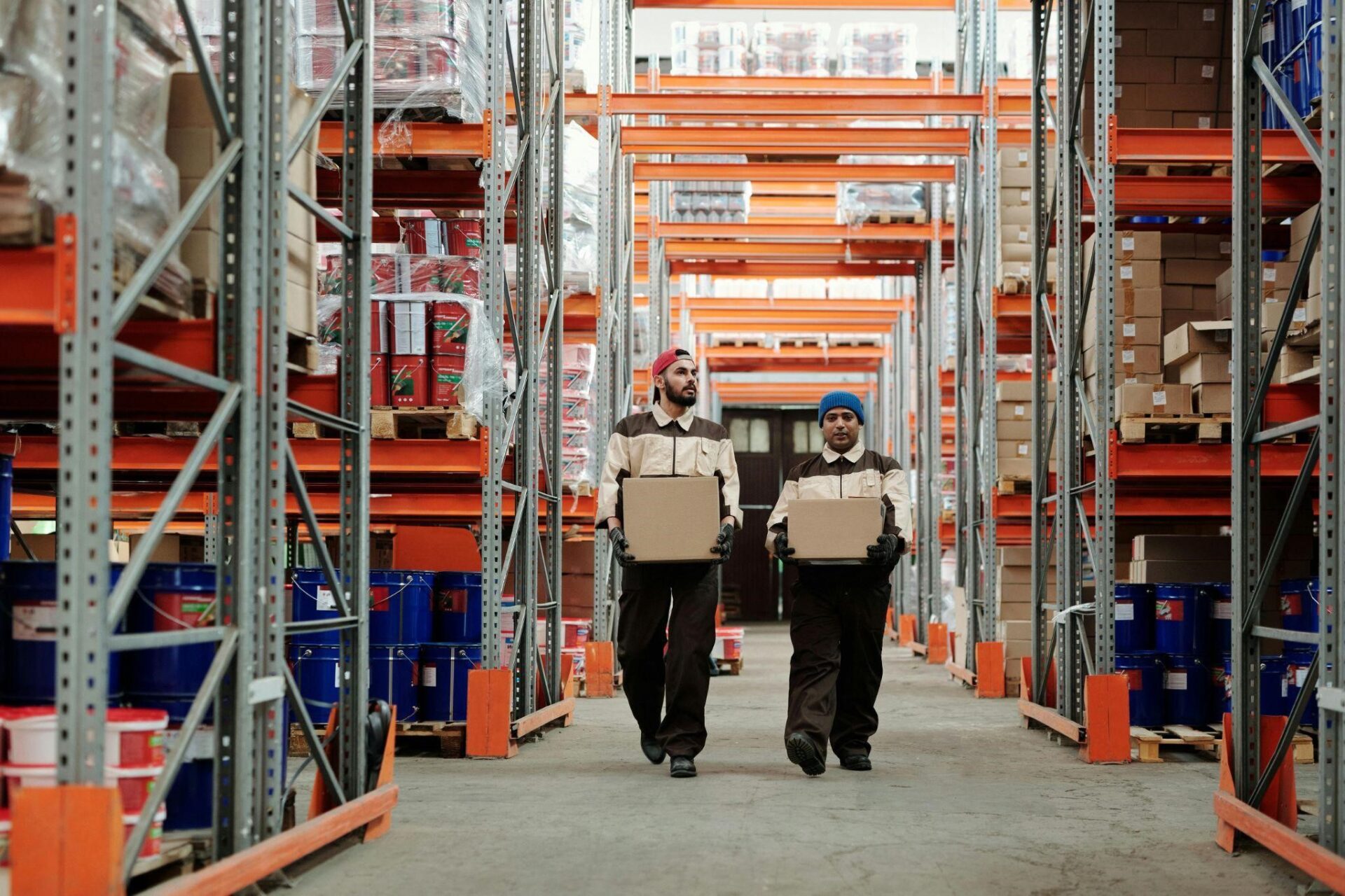 Two men carry boxes inside of a warehouse – AMS Fulfillment