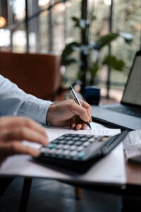 A person using a calculator - AMS Fulfillment